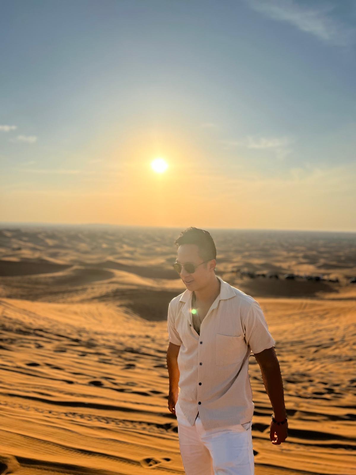 Christian in the desert at sunset near Dubai
