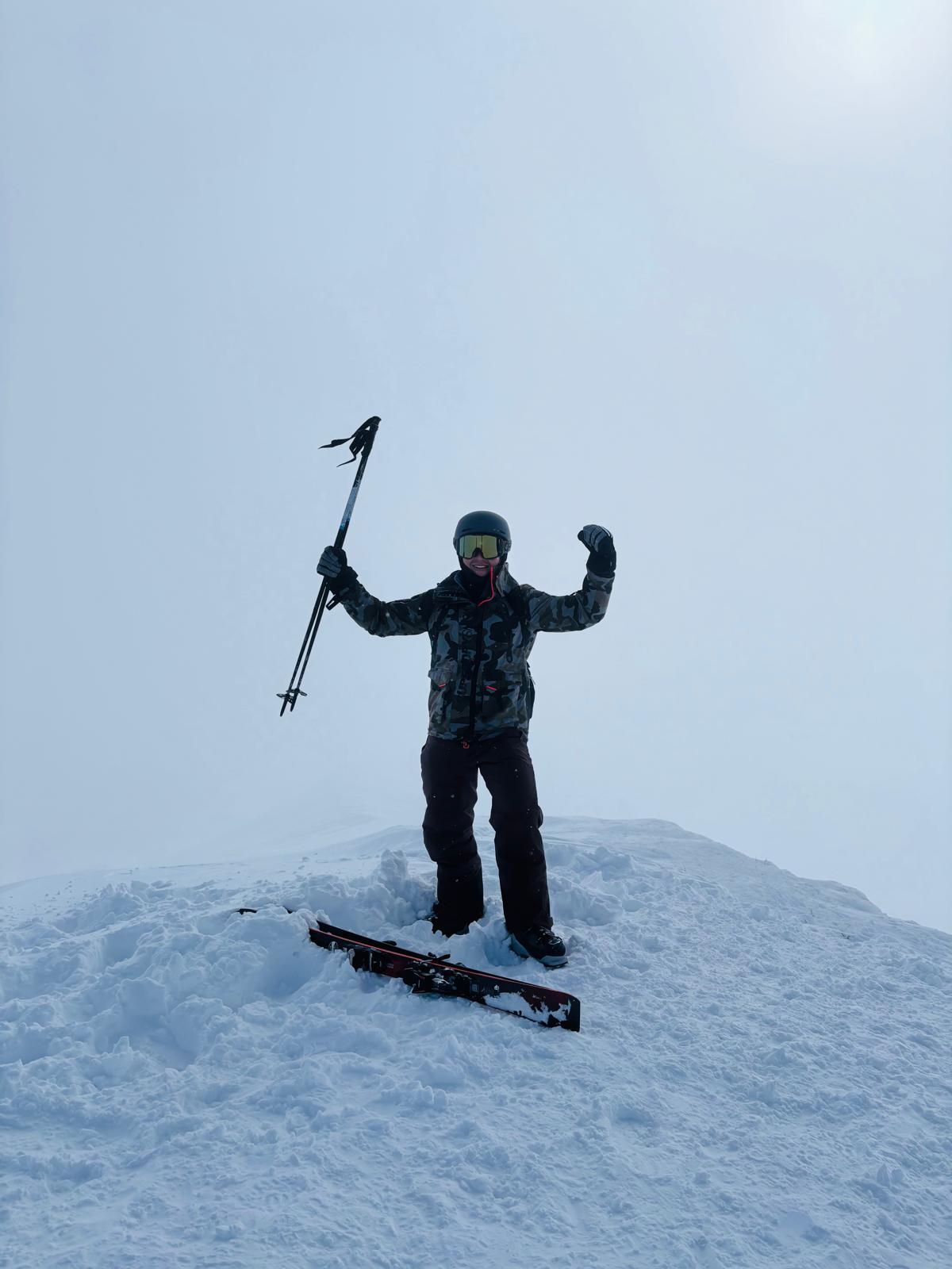 Christian skiing on a snowy summit in Japan